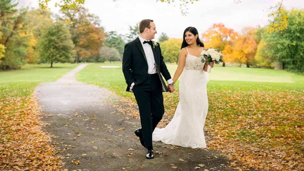 Wedding couple walking the path at The Legacy Club at Woodcrest weddings in Cherry Hill NJ