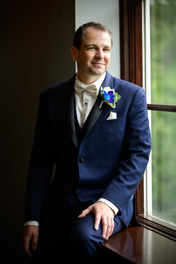 Grooms portrait by the window at Bradford Estate.