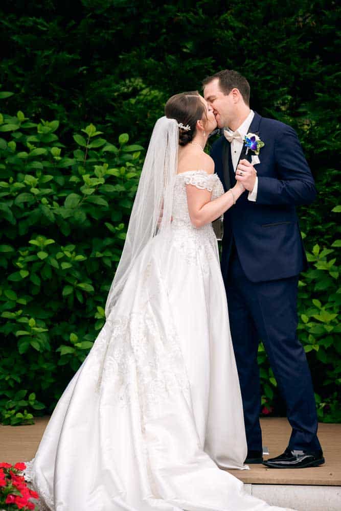 A warm embrace and kiss to seal the marriage after the ceremony at Bradford Estate.