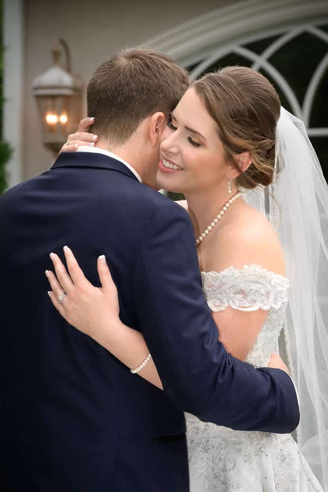 A sweet and romantic embrace between the bride and groom outside Bradford Estate.