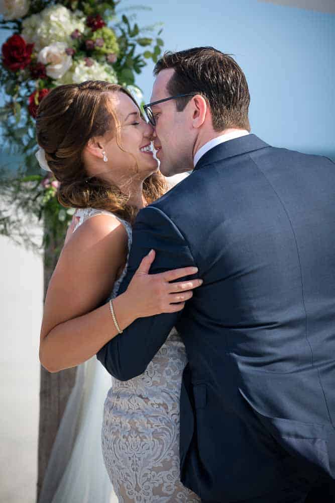 groom kisses is wife after vow exchange at the ICONA Diamond Beach Wedding.