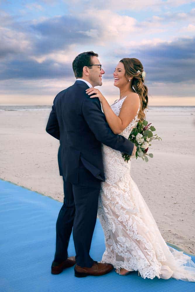 Bride and groom posing on the beach at the ICONA Diamond Beach wedding.