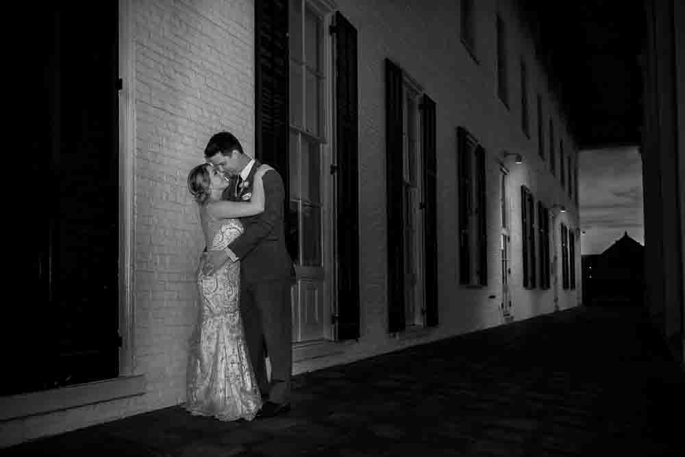 Night time black and white photo of bride and groom outside Congress Hall in Cape May NJ