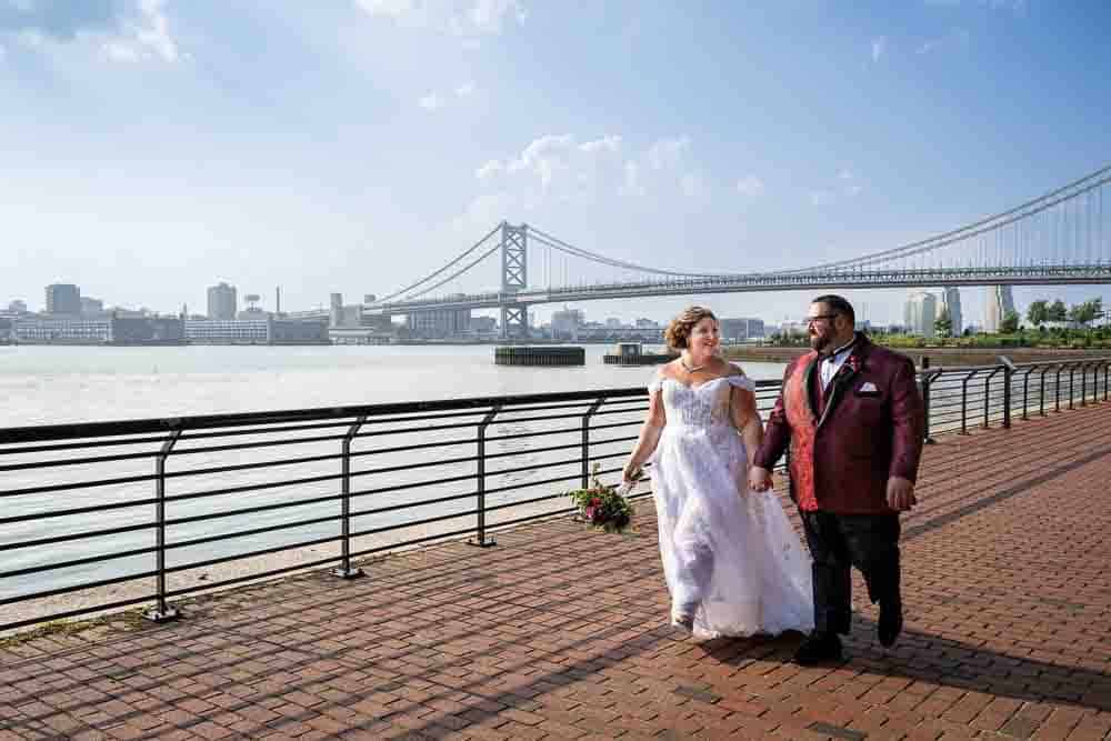 Bride and Groom taking a stroll on the walkway alongside the Delaware river.