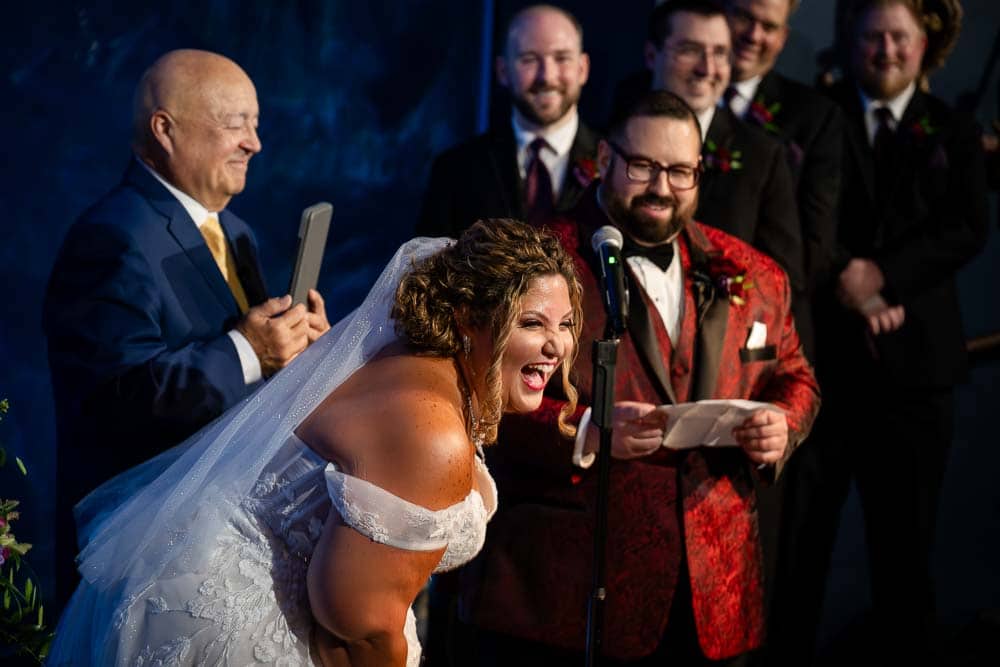 Bride burst out laughing during the wedding ceremony at Adventure Aquarium.