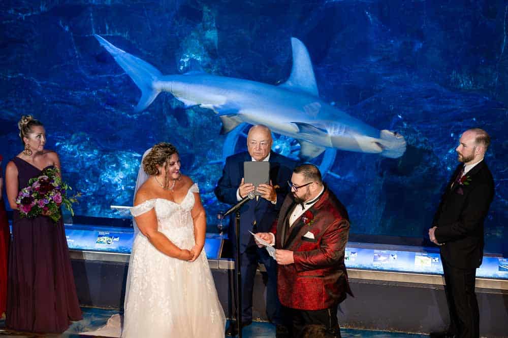 Reading the vows during the Adventure Aquarium wedding ceremony.