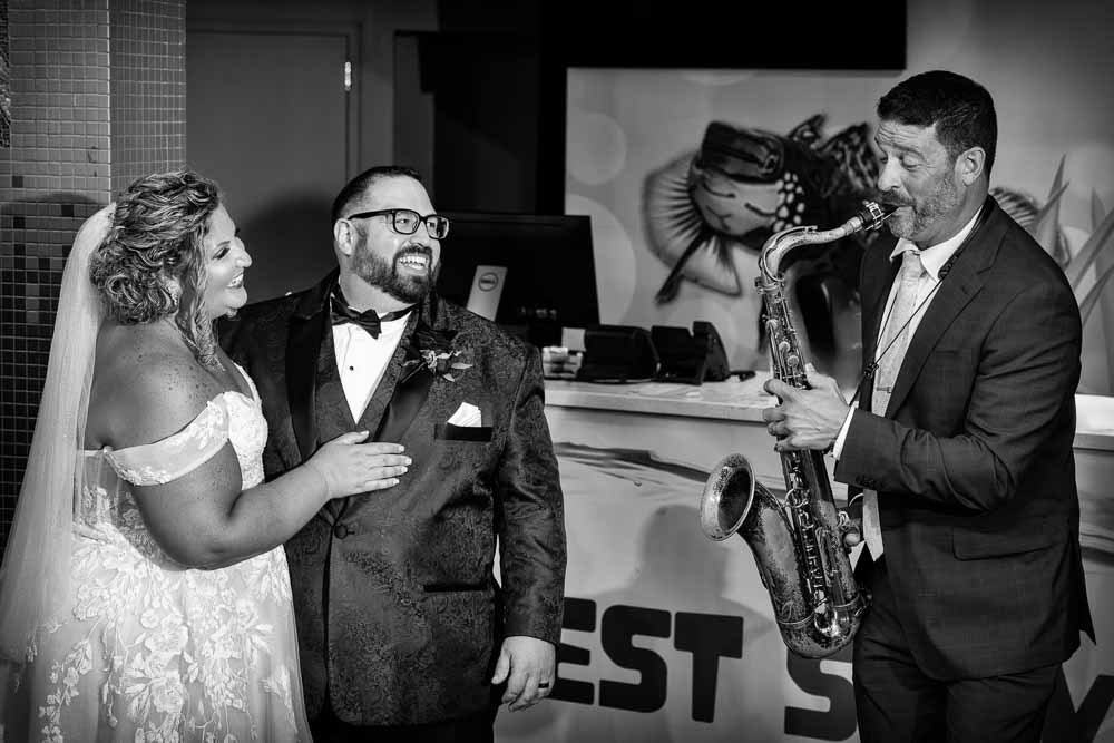 Saxophone player entertaining the bride and groom during the wedding reception in Camden NJ