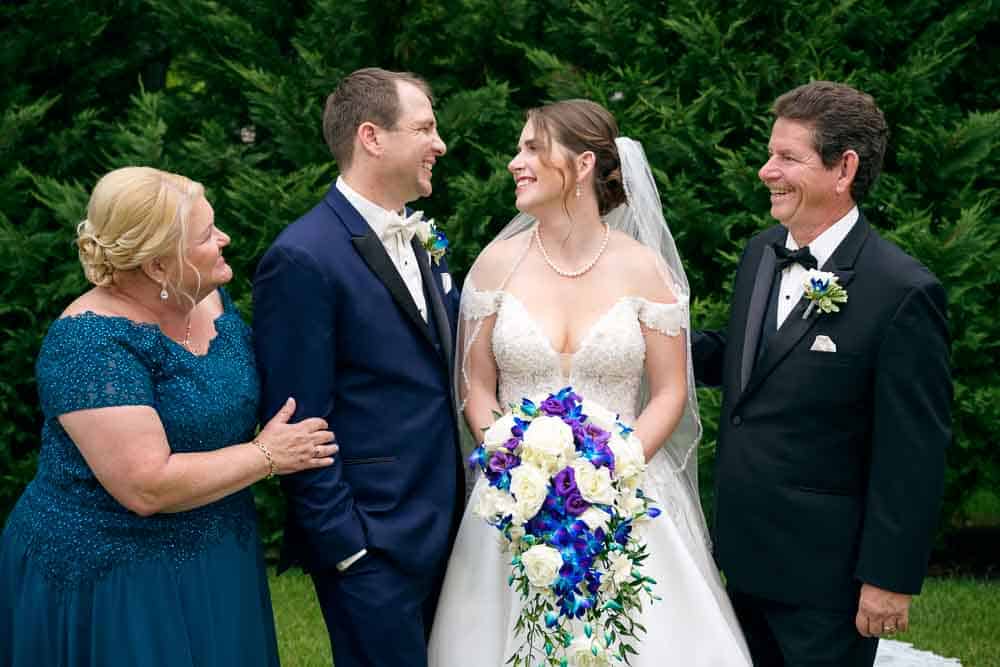 A friendly encounter between the bride and groom with the brides parents at Bradford Estate.