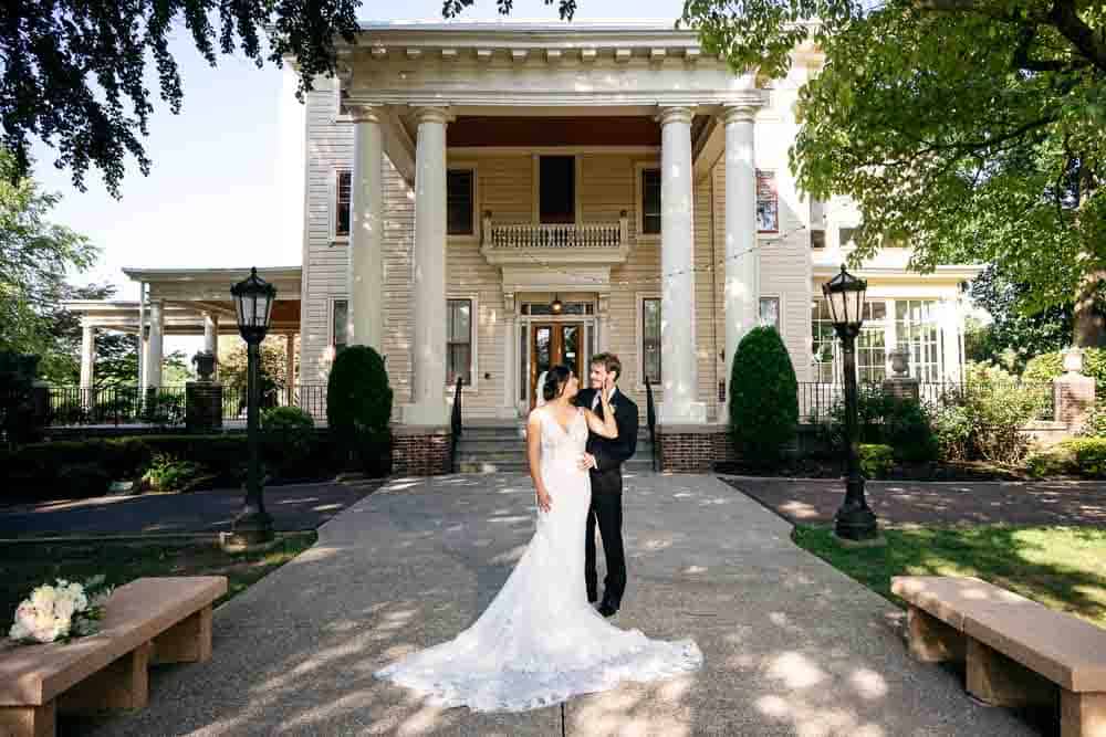 Bride and Groom in front of Collingswood Grand Ballroom Mansion.