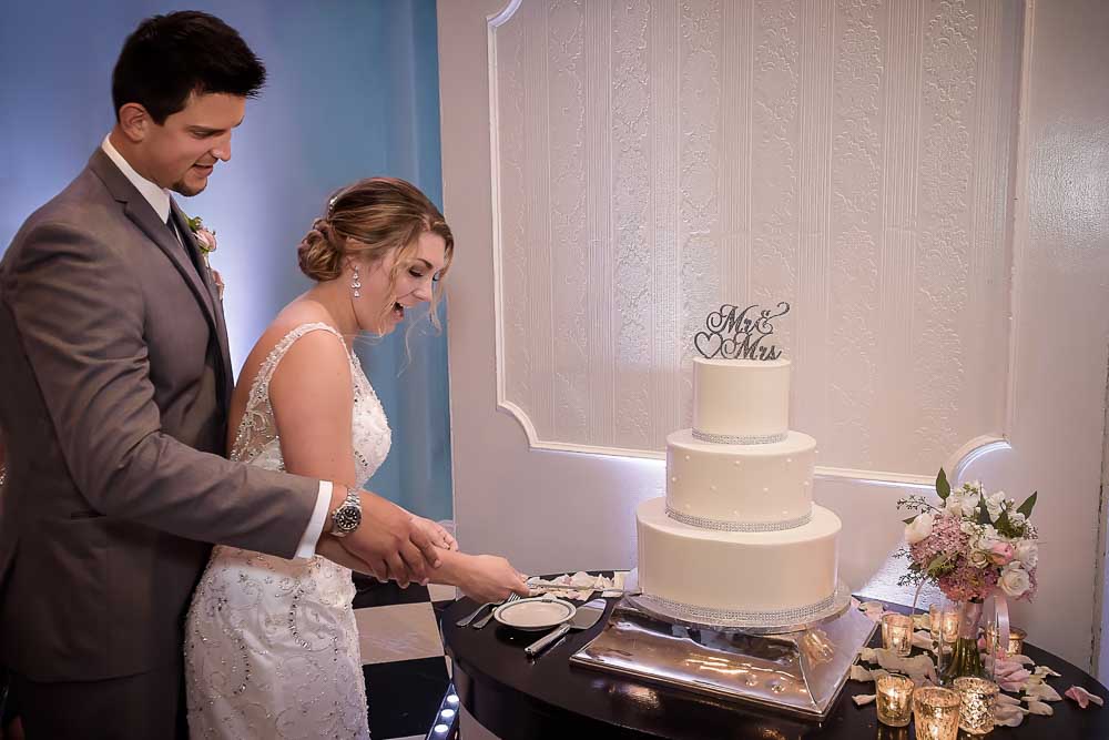 Bride and groom cutting their wedding cake