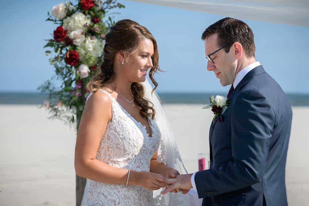 bride and groom exchange wedding rings at the ICONA Diamond Beach Wedding.