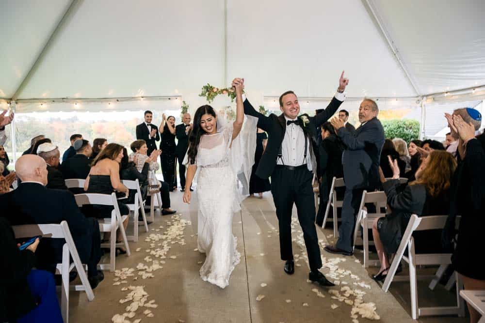 Bride and groom walking down the aisle after the ceremony at the Legacy Club at Woodcrest in Cherry Hill NJ