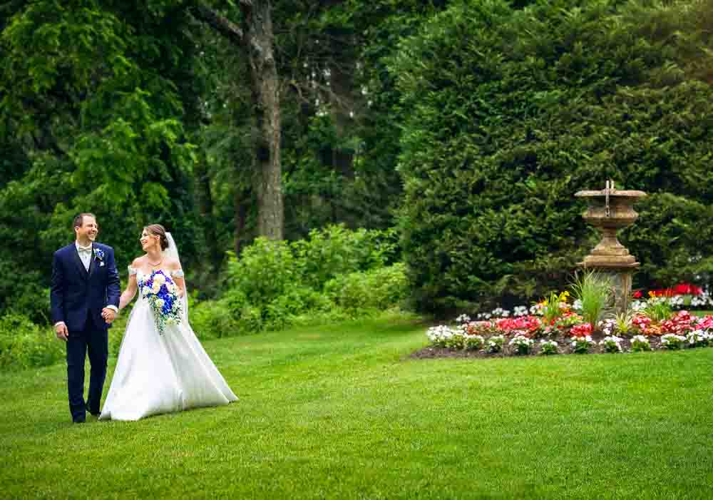 The bride and groom take a stroll around the garden at Bradford Estate.