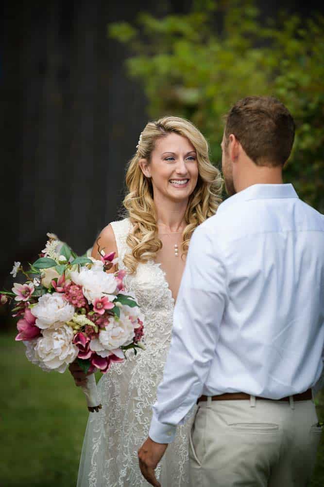 Bride and Groom glancing at each other at the Cape May Winery