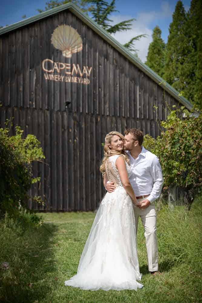 bride and groom exchange a kiss during the first look at the Cape May Winery