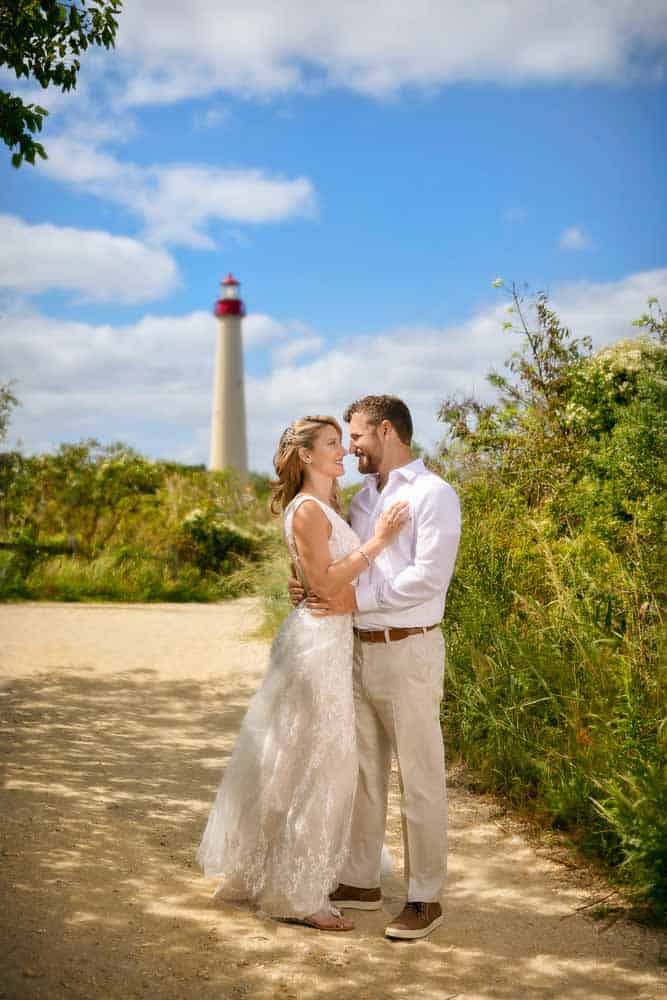 Bride and Groom posing in front of the Cape May lighthouse