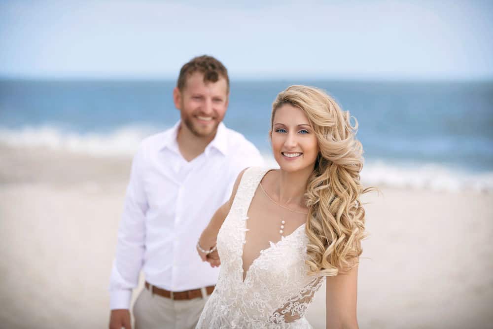 bride and groom having fun on the beach at Cape May.