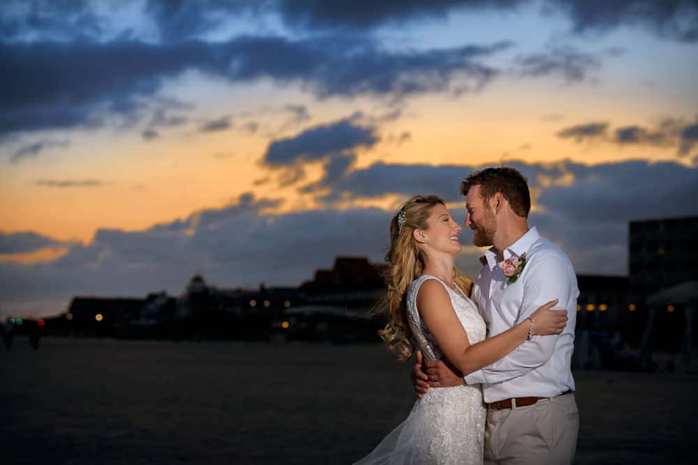 Bride and groom embracing during a Cape May sunset at the Grand Hotel of Cape May