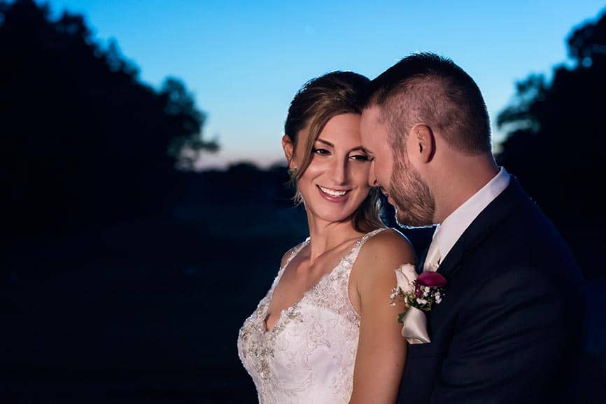 Couple embracing during sunset at Blue Heron Pines Golf Club Wedding