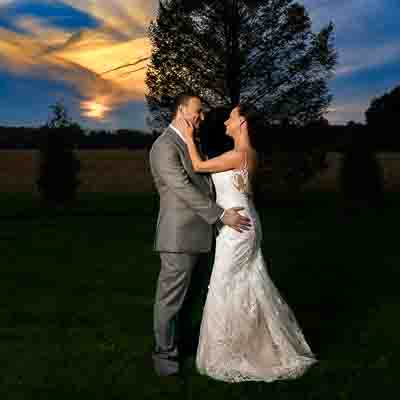 Bride and groom holding each other during sunset