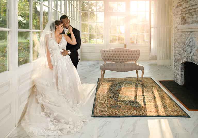 Bride and Groom posing inside the Atrium in Collingswood Grand Ballroom