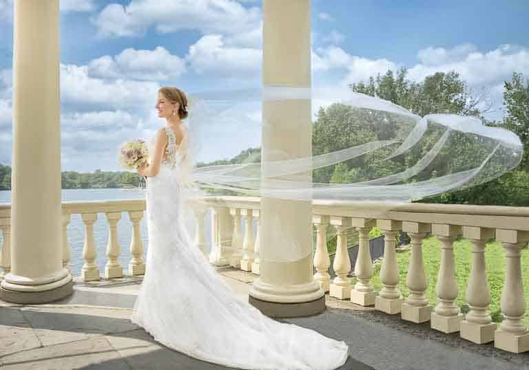 Bride posing by the Schkuykill River in Philadelphia before her Hotel Monaco wedding ceremony.