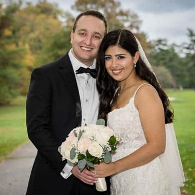 Laura and Michael embracing under the stone gazebo at Brigalias in Sicklerville NJ