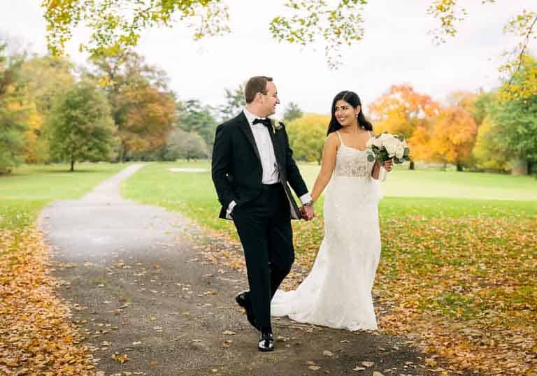 Bride and groom walking on the path at Legacy Club in Woodcrest in Cherry Hill NJ