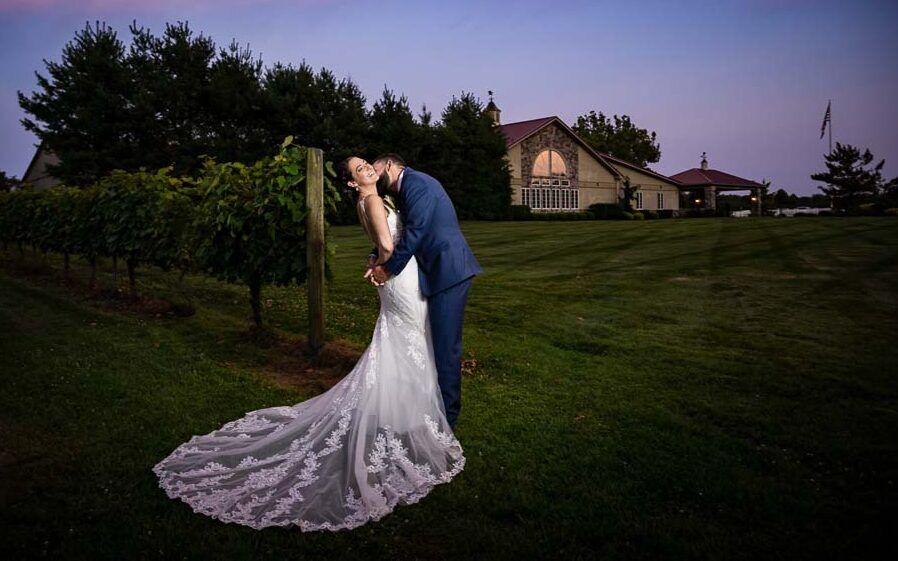 Couple having fun outside the venue as the sun sets at Valenzano Winery.