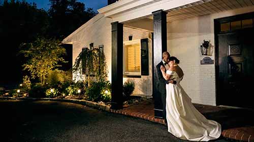 Bride and groom embracing each other in front of the Marian House in Cherry Hill NJ